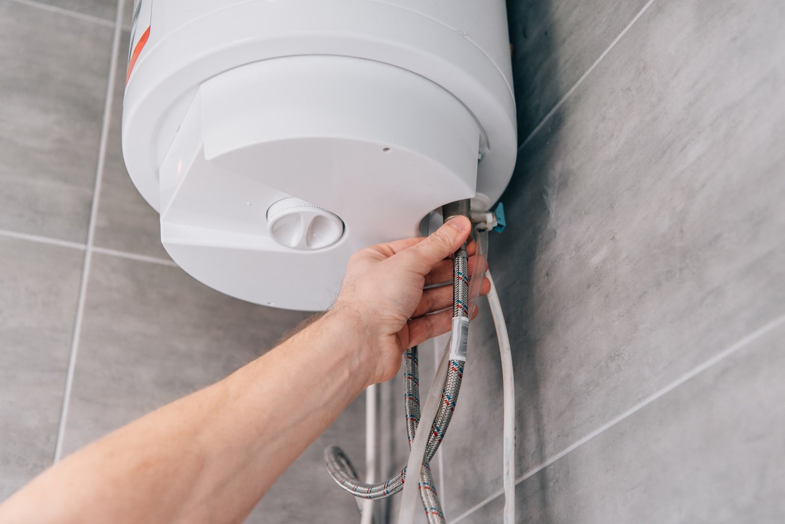 cropped-shot-of-male-plumber-repairing-electric-boiler-in-bathroom.jpg